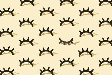 Fototapeta premium Creative pattern with wooden eyelashes on a pastel yellow background. Minimalist concept. Isometric layout.