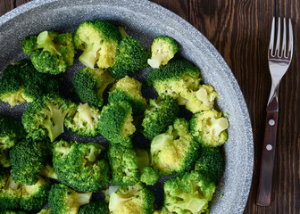 Cabbage broccoli in a frying pan close-up, top view, healthy eating