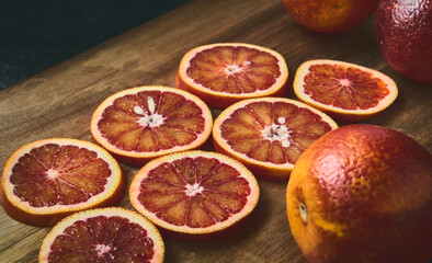 Red jucy oranges round sliced, close-up, shallow depth of field, stylized