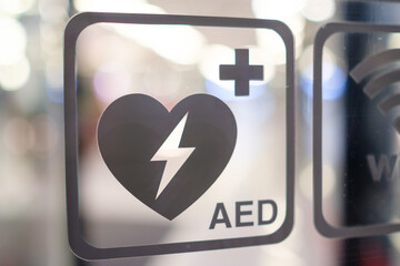 An automated external defibrillator AED sign in public place. Emergency defibrillator.  - obrazy, fototapety, plakaty