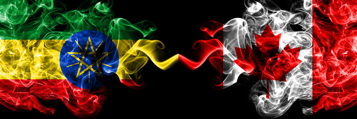 Ethiopia, Ethiopian vs Canada, Canadian smoky mystic flags placed side by side. Thick colored silky abstract smoke flags.