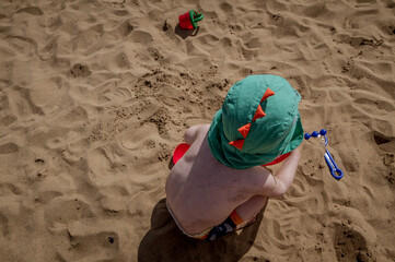 Baby boy playing in the sand