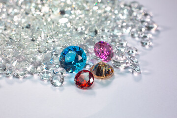 colorful diamonds are placed on a pile of white diamonds And keep turning. video 4k resolution shoot in studio.