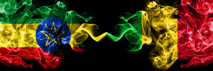 Ethiopia, Ethiopian vs Mali smoky mystic flags placed side by side. Thick colored silky abstract smoke flags.