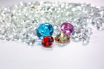 colorful diamonds are placed on a pile of white diamonds And keep turning. video 4k resolution shoot in studio.
