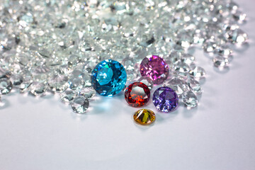 colorful diamonds are placed on a pile of white diamonds And keep turning. video 4k resolution shoot in studio.