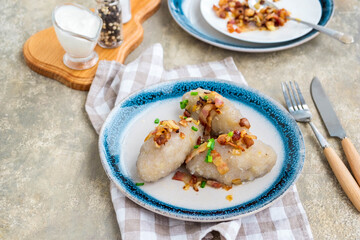 Traditional Lithuanian dish Zeppelin, boiled potato dumplings stuffed with minced pork, on a...
