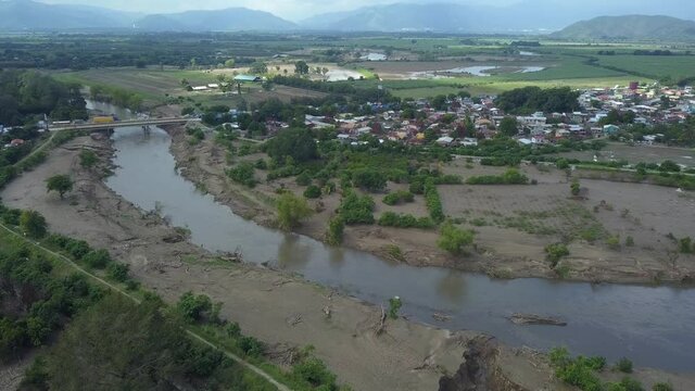 Post destruction of a hurricane in a city with a river and a bridge