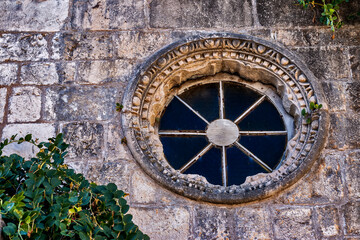 The facade of old houses. Cityscape of the old town. Round window