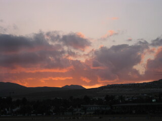 red orange sunset over black mountains