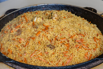 Traditional uzbek pilaf or plov in big plate