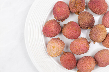 Lychee fruit isolated above white background