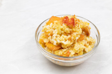Risotto served in the bowl above white background