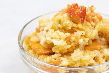 Risotto served in the bowl above white background