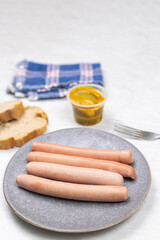 Cooked Frankfurters served on the plate for the breakfast