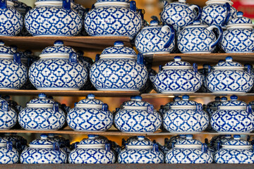 Many colorful tea set on stall for sale in local street market in Thailand. Close up