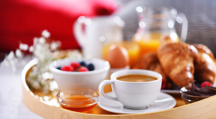 A tray with breakfast on a bed in a hotel room