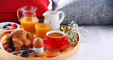 A tray with breakfast on a bed in a hotel room