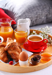 A tray with breakfast on a bed in a hotel room