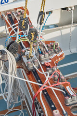 Set of ropes for management of the sailboat of different color, the signature to each rope, rollers, levers, carbines, clamps, the dragon sailboat