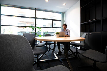 Young man using a laptop in a workshop