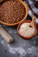 fresh natural buckwheat flour on a dark stone background culinary concept