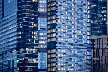Office and residential skyscrapers facades close up. Reflections and glare on the glass facades of...