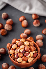 fresh natural hazelnuts on a dark stone background