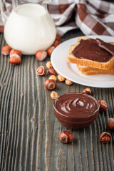 toasts with chocolate butter on a dark wooden rustic background