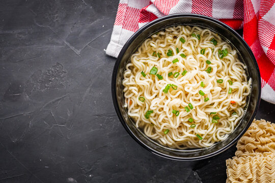 instant egg noodles on a dark stone background