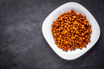 fried chickpeas on a dark stone background