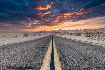 Fototapeta na wymiar Route 66 in the desert with scenic sky. Classic vintage image with nobody in the frame.