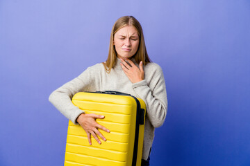 Young russian woman holding suitcase to travel suffers pain in throat due a virus or infection.