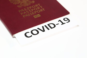 passport and document with text COVID-19 inside close up, concept of immunological travel document