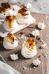 Mini pavlova meringue cakes on light background