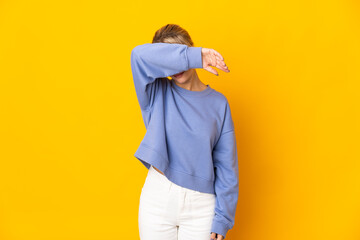 Young Russian woman isolated on yellow background covering eyes by hands