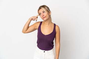 Young Russian woman isolated on white background making the gesture of madness putting finger on the head