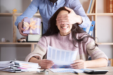 happy woman with man holding gift box