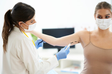 Plastic surgeon consulting a female patient