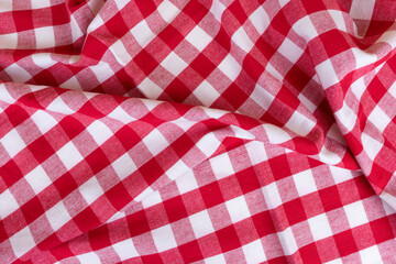 Fototapeta na wymiar Traditional white and red kitchen chekered towel rustic style for a picnic or tablecloth with tartan pattern. Gingham crampled texture for table napkin