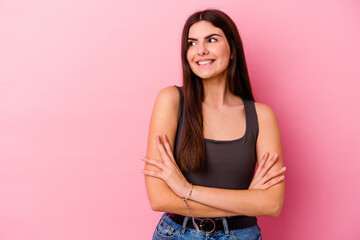 Young caucasian woman isolated on pink background smiling confident with crossed arms.