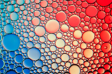 Abstract background and texture of oil drops on water with different colors