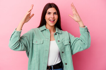 Young caucasian woman isolated on pink background receiving a pleasant surprise, excited and...