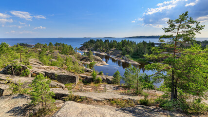 Fototapeta na wymiar Stunning view from the highest point of the Ladoga skerries on Honkasalo island in the summer.