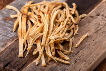 stripes of sliced pancake on wood