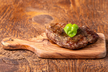 overview of a grilled steak on wood