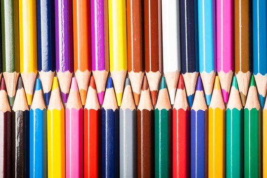 Background of colored pencils interspersed with each other