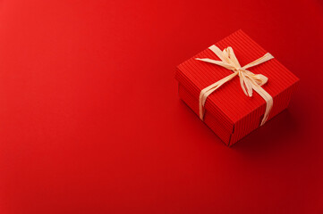 red gift box on red background 