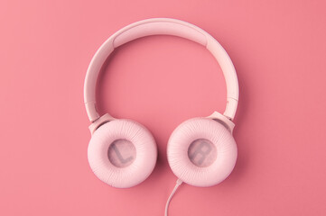 pink headphones on dark pink background 