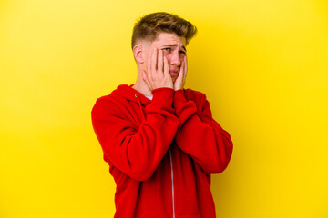 Fototapeta premium Young caucasian man isolated on yellow background whining and crying disconsolately.